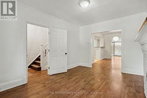 Toronto (Yonge-Eglinton) apartment for rent - A room with wooden floors and white walls, with a doorway leading to another room.