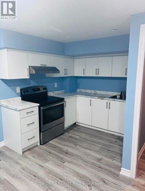 Cambridge apartment for rent - A kitchen with a black oven and white cabinets.