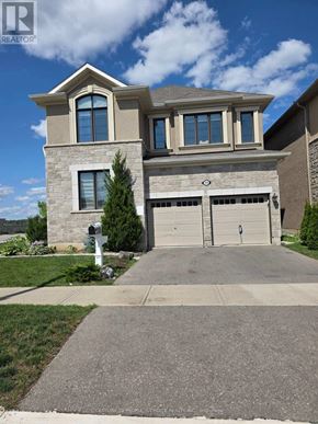 Milton (Cb Cobban) apartment for rent - A house with a garage and a driveway in front of it.