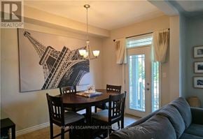Grimsby (Grimsby Beach) townhouse for rent - A dining room with a large Eiffel Tower picture on the wall.