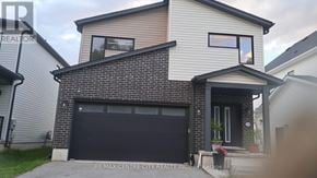 London North (North S) multi-family for rent - A modern house with a black garage door is for sale.