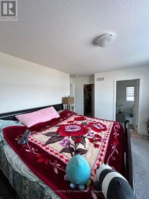 London North (North S) multi-family for rent - A bedroom with a bed covered in a red and white comforter.