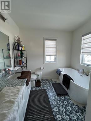 London North (North S) multi-family for rent - A bathroom with a white tub, toilet, and sink.