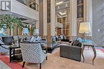 Toronto (Bay Street Corridor) condo for rent - A living room with a glass table and a grey sofa.