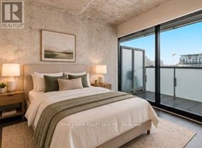 Toronto (Waterfront Communities) condo for rent - A bedroom with a large bed, a painting on the wall, and a sliding glass door.