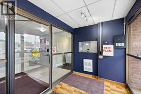 Windsor condo for rent - The image shows a glass door entrance to a building with a sign that reads "FIRE PLAN.".