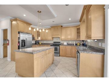 Surrey apartment for rent - A kitchen with wooden cabinets and granite countertops.