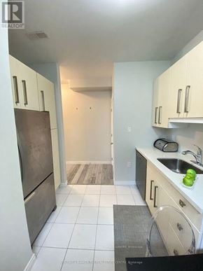 Barrie (Letitia Heights) multi-family for rent - A kitchen with white cabinets and a white fridge.