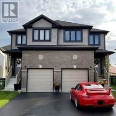 Guelph (Grange Road) apartment for rent - A red sports car is parked in front of a two-story house with a garage.