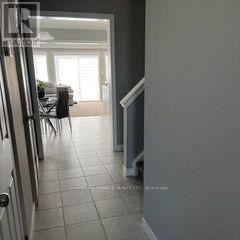 Guelph (Grange Road) apartment for rent - A hallway with a dining room in the background.