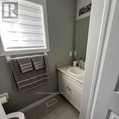 Guelph (Grange Road) apartment for rent - A bathroom with a toilet, sink, and towel.