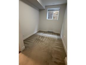 Surrey apartment for rent - A room with a carpeted floor and a window.