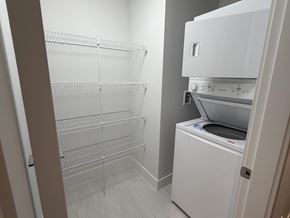 Surrey apartment for rent - A white refrigerator with its door open in a kitchen.
