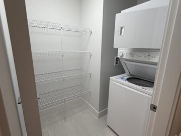 Surrey apartment for rent - A white refrigerator with its door open in a kitchen.