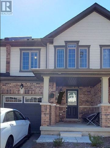 Cambridge townhouse for rent - A white car is parked in front of a house.