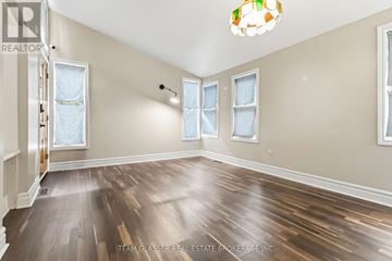 London East (East F) apartment for rent - A room with wooden floors and a light fixture on the wall.
