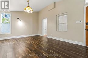London East (East F) apartment for rent - A room with wooden floors and a chandelier hanging from the ceiling.
