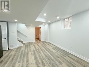 Hamilton (Stoney Creek) multi-family for rent - A spacious room with a staircase and a door at the end.
