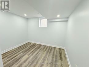 Hamilton (Stoney Creek) multi-family for rent - A room with wooden flooring and white walls.