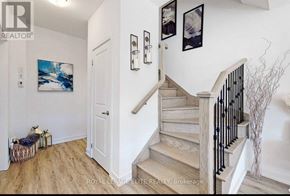 Vaughan (Vaughan Grove) townhouse for rent - A hallway with a staircase and a painting on the wall.