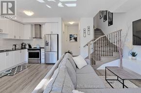 Vaughan (Vaughan Grove) townhouse for rent - A modern kitchen with white cabinets and a stainless steel refrigerator.