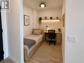 Toronto (Centennial Scarborough) condo for rent - A small bedroom with a bed, desk, and chair.