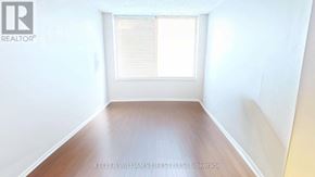 London East (East F) condo for rent - A room with a window and wooden floor.