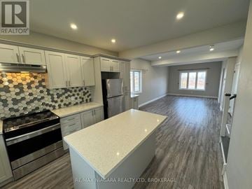 Niagara Falls (Brown) apartment for rent - A kitchen with a stove top oven and a counter top.