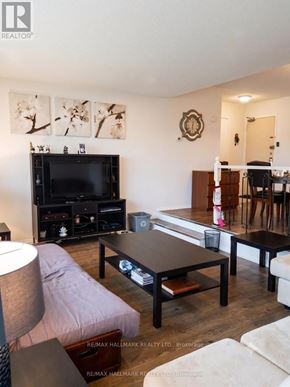 Toronto (Henry Farm) condo for rent - A living room with a flat screen TV and a wooden coffee table.