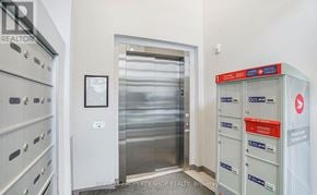 Ottawa condo for rent - A hallway with a metal elevator and mailboxes on the right.
