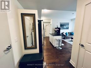 Ottawa condo for rent - A hallway with a mirror, a bench, and a bar area.