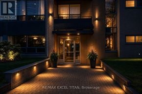 Toronto (Mount Pleasant West) condo for rent - A modern building entrance with a glass door and a balcony above it.