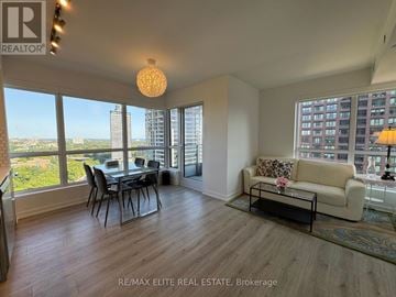 Toronto (North St. James Town) condo for rent - A spacious living room with a dining table and chairs, a sofa, and a view of the city.