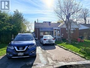 Toronto (Wexford-Maryvale) apartment for rent - A blue Nissan SUV is parked in front of a white car in a driveway.