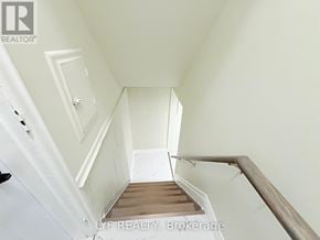 Toronto (Wexford-Maryvale) apartment for rent - A stairway with a white wall and wooden steps.