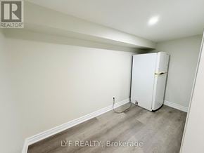 Toronto (Wexford-Maryvale) apartment for rent - A white refrigerator in a room with a wooden floor.