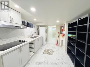 Toronto (Wexford-Maryvale) apartment for rent - A clean, white kitchen with a sink, stove, and refrigerator.