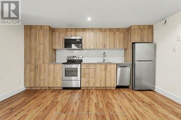 Ottawa apartment for rent - A kitchen with wooden cabinets and stainless steel appliances.