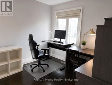 Oakville (Wt West Oak Trails) apartment for rent - A room with a desk, chair, and a window.