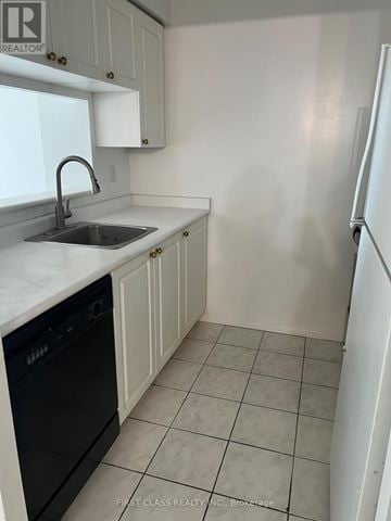Toronto (Newtonbrook East) condo for rent - A kitchen with white cabinets and a black dishwasher.