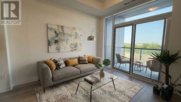 Vaughan (Concord) condo for rent - A living room with a grey couch and a painting on the wall.