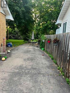 Burlington (Lasalle) apartment for rent - A residential alley with a wooden fence on one side and a house on the other.