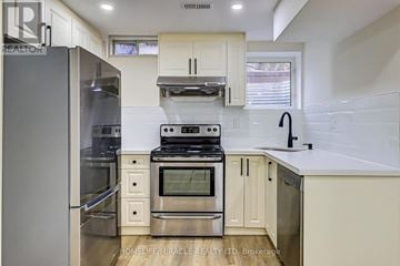 Mississauga (Meadowvale Village) apartment for rent - A modern kitchen with stainless steel appliances and white cabinets.