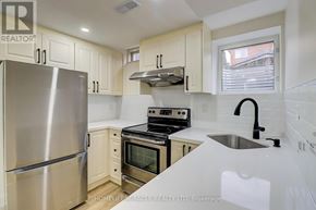 Mississauga (Meadowvale Village) apartment for rent - A kitchen with a stainless steel refrigerator, oven, and sink.