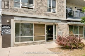Waterloo condo for rent - A building with a sign that says "PRIVATE PROPERTY" and "UNAUTHORIZED VEHICLES WILL BE TOUCHED".