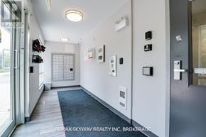 Waterloo condo for rent - A hallway with a brokerage sign on the wall.