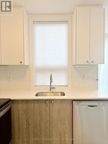 Kitchener townhouse for rent - A kitchen with a sink and a window.