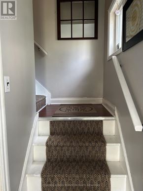 St. Catharines (Fairview) duplex for rent - A stairway with a brown carpeted step and white risers.