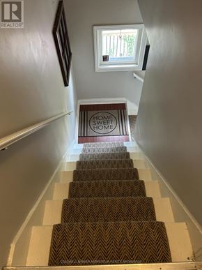 St. Catharines (Fairview) duplex for rent - A staircase with a sign that says "Sweet Home" on it.