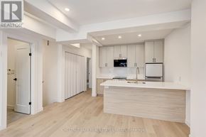 Toronto (Annex) multi-family for rent - A modern kitchen with white cabinets and a wooden island.